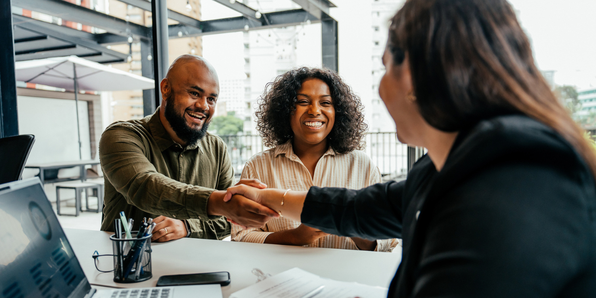Couple-shaking-hands-with-insurance-agent